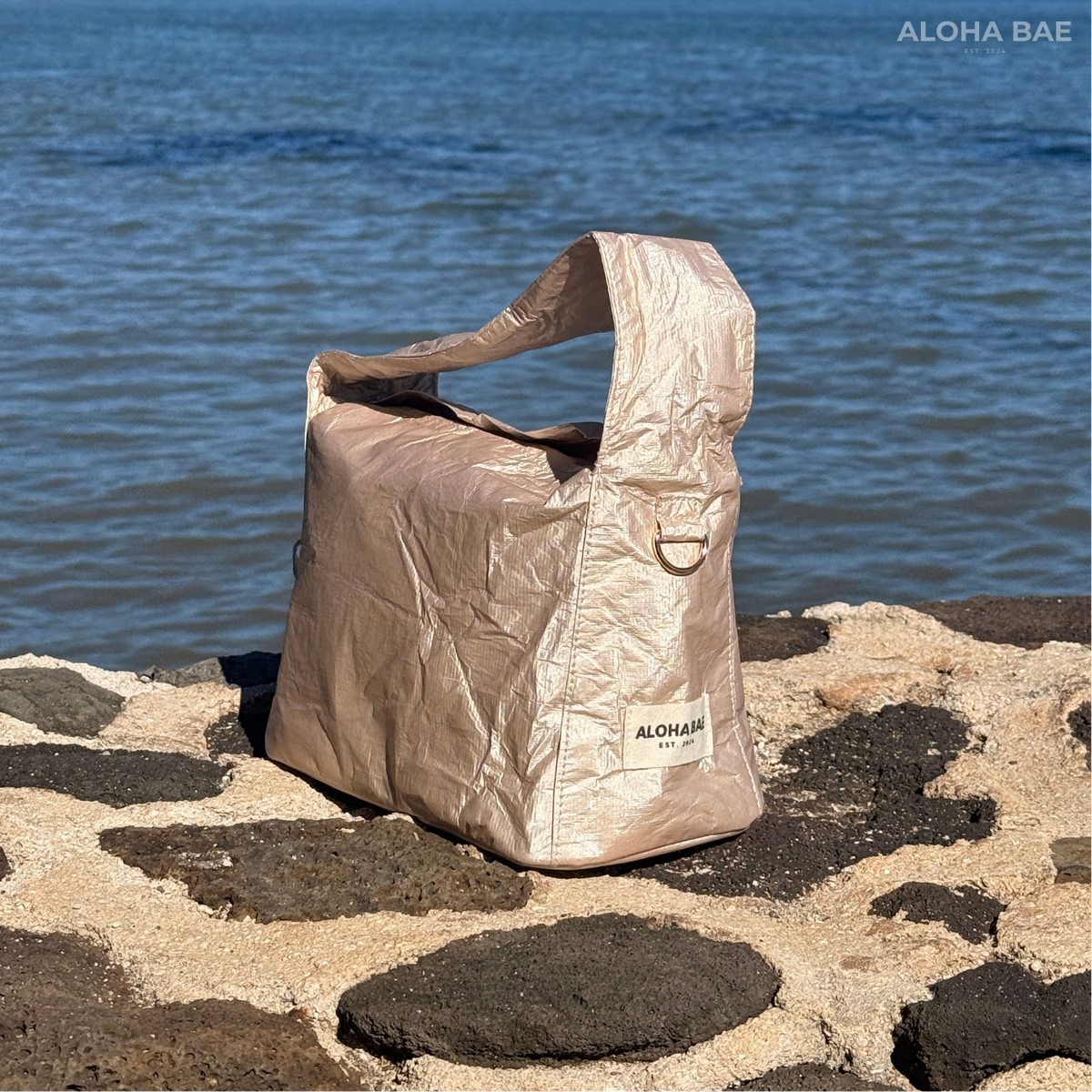 Aloha Bae champagne-colored hobo bag with a relaxed, slouchy style and gold-tone hardware, perfect for casual or evening wear.