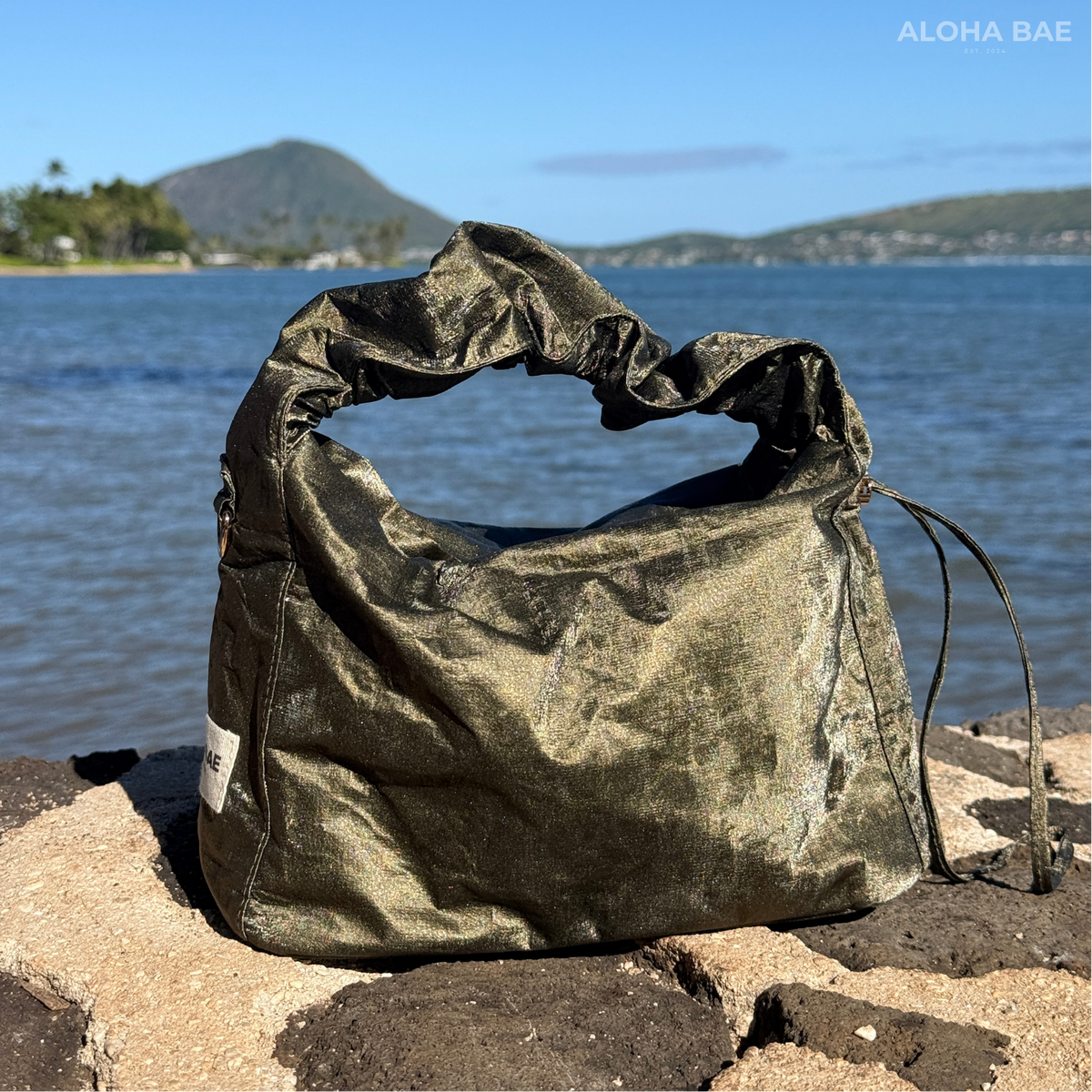 Aloha Bae Maritime Pine hobo bag with woven design, featuring a rounded shape, leather strap, and nautical-inspired accents.