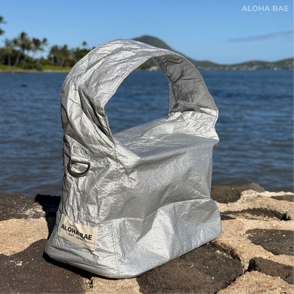 Aloha Bae silver hobo bag by alohabae featuring a sleek, metallic finish and a casual, slouchy design with shoulder strap.