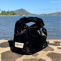 Aloha Bae black sheen hobo bag with a slouchy shape and shoulder strap, featuring sleek, shiny material and minimalist design.