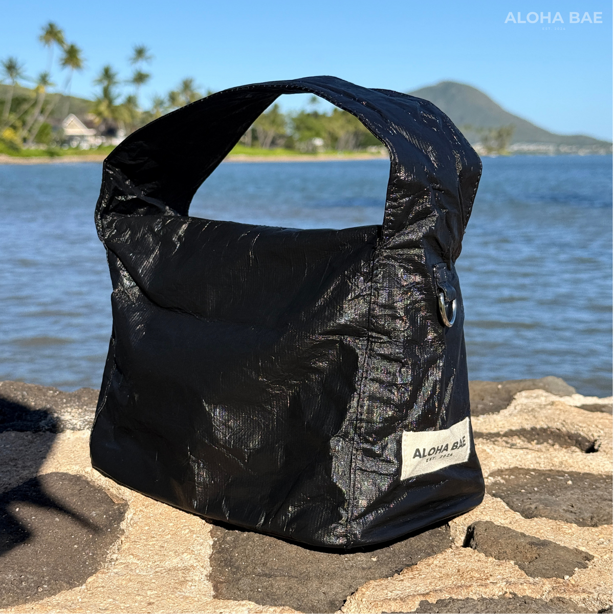 Aloha Bae matte black hobo bag with soft leather texture and curved shoulder strap, stylish and spacious for everyday use.