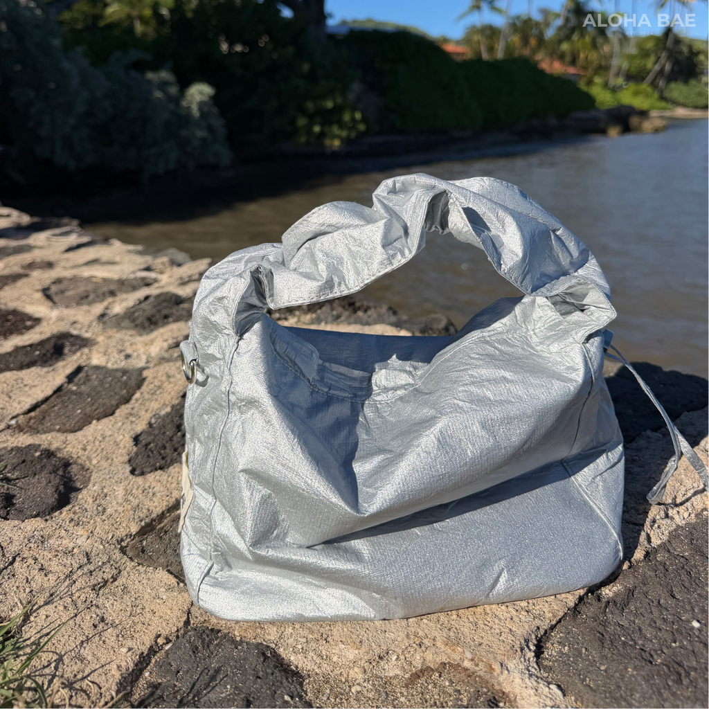 Alohabae silver hobo bag with a slouchy design and adjustable strap, featuring a metallic finish and stylish casual look.